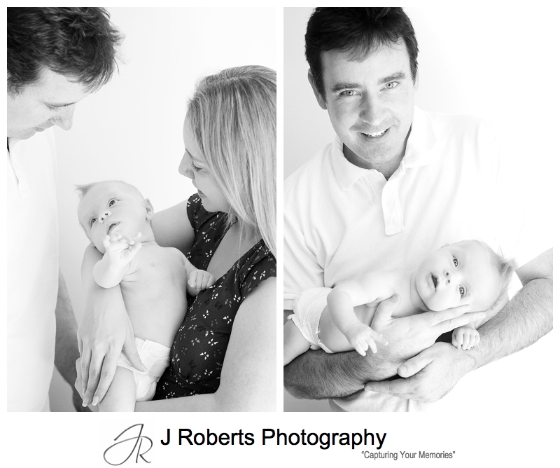 B&W portraits of a baby in her parents arms - sydney baby photographer